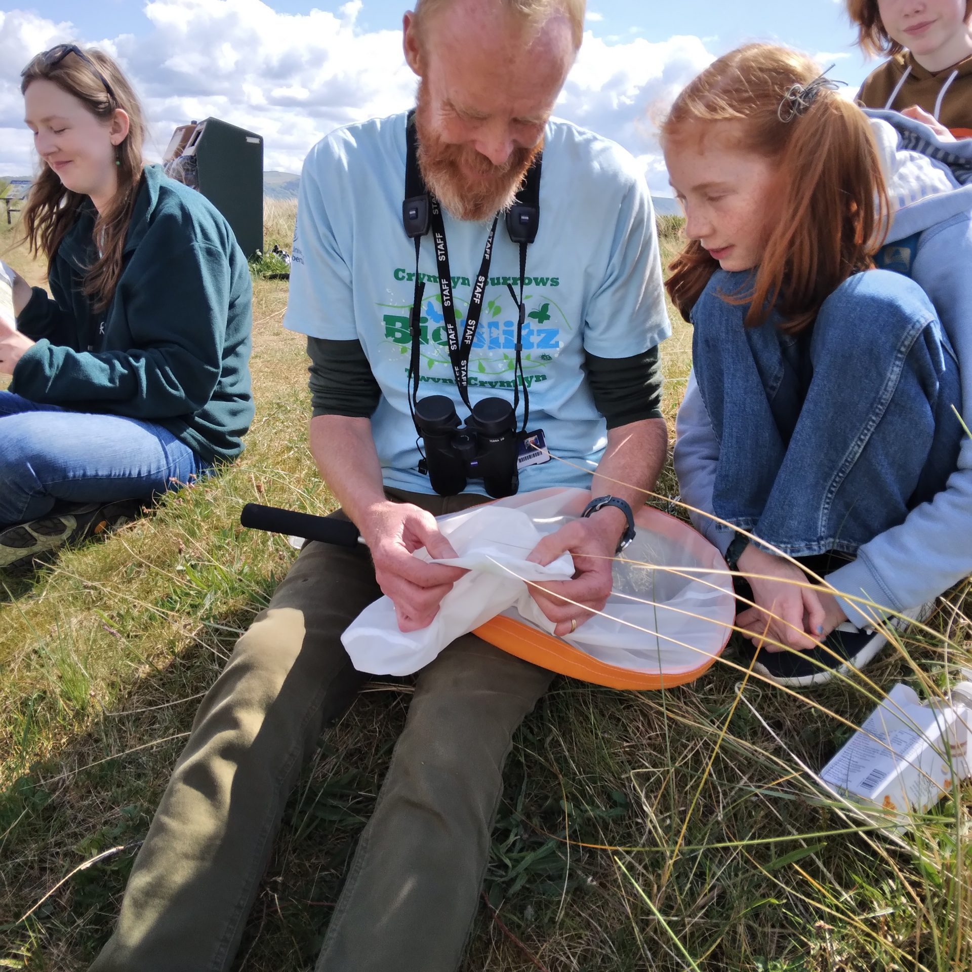 Volunteers take part in a bug net sweep on the dunes