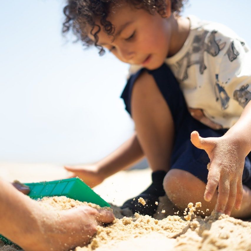A child plays in the sand